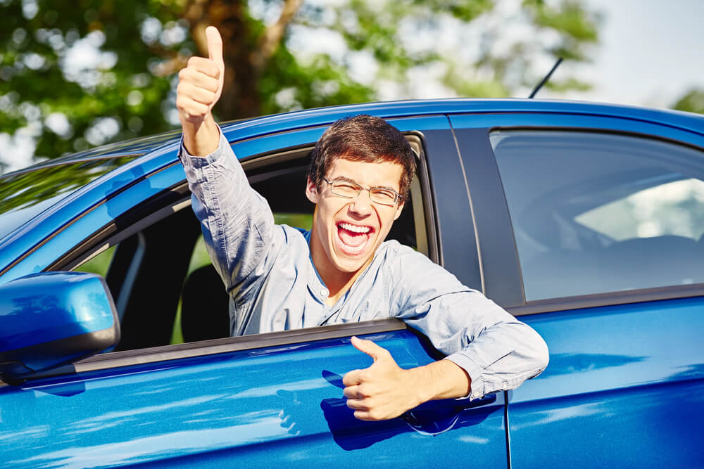 young male with thumbs up out of the car window after passing learners test at driving school mandurah
